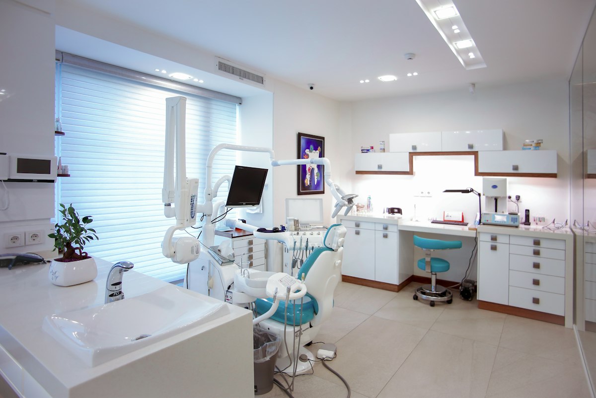 Premier oral surgery modern clinic and dentist working
